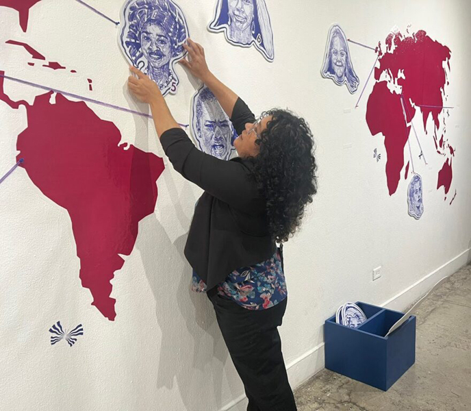 Foto 4. Patricia Toledo montando la exposición Voces de niñas (2025)